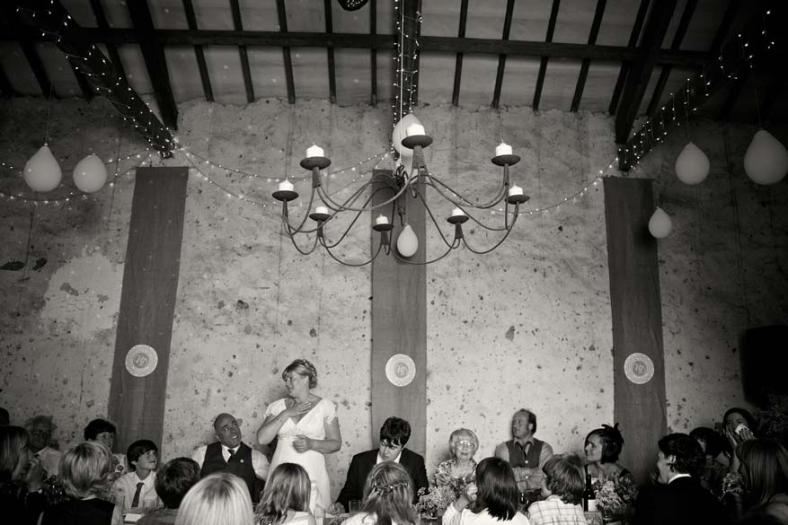 Bride gives a wedding speech inside the barn