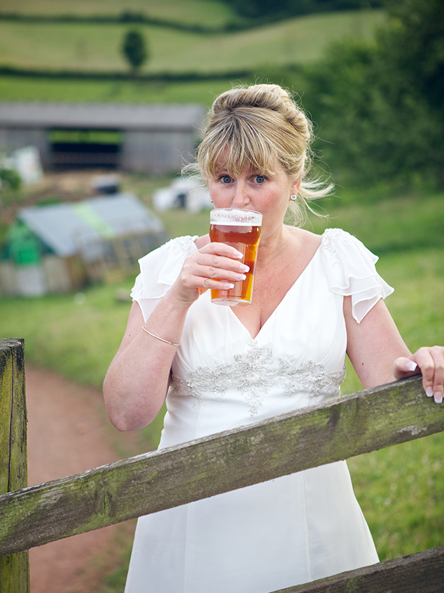 The bride enjoys a well earned pint!